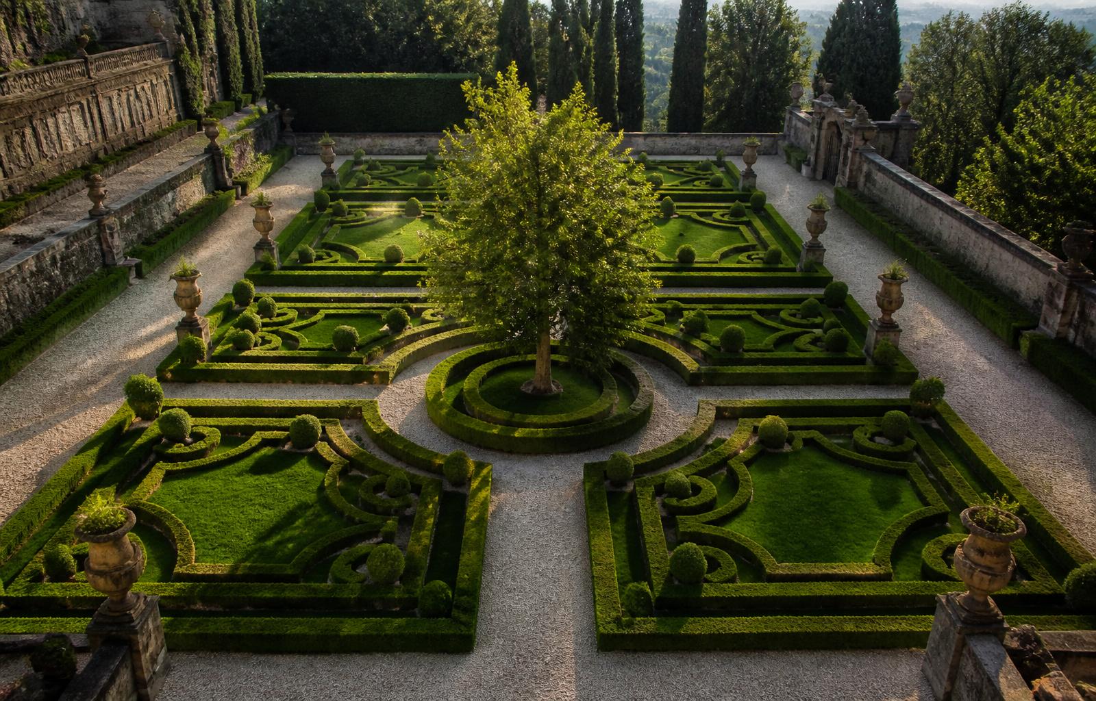 A formal Italian garden seven beds around a central tree.
